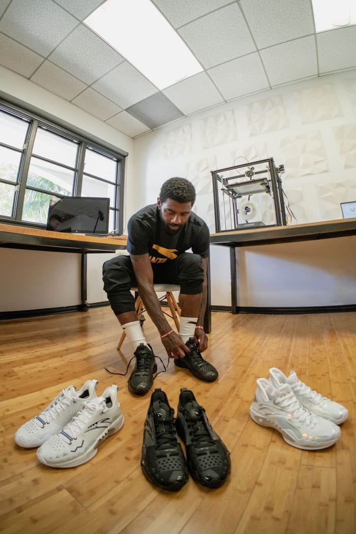 Kyrie Irving poses with ANTA sneakers.